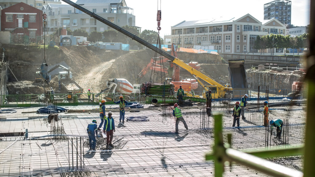 Construction Workers Pouring Concrete Foundation