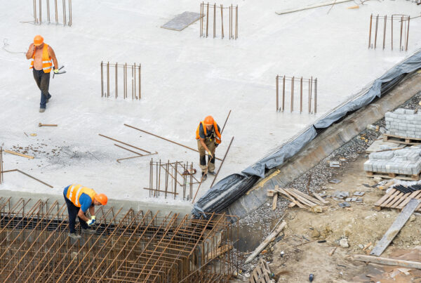 Construction Workers Laying The Building Foundation